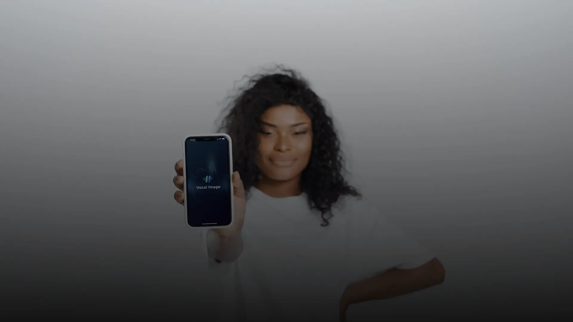 A woman holding a phone with the voice coaching app open